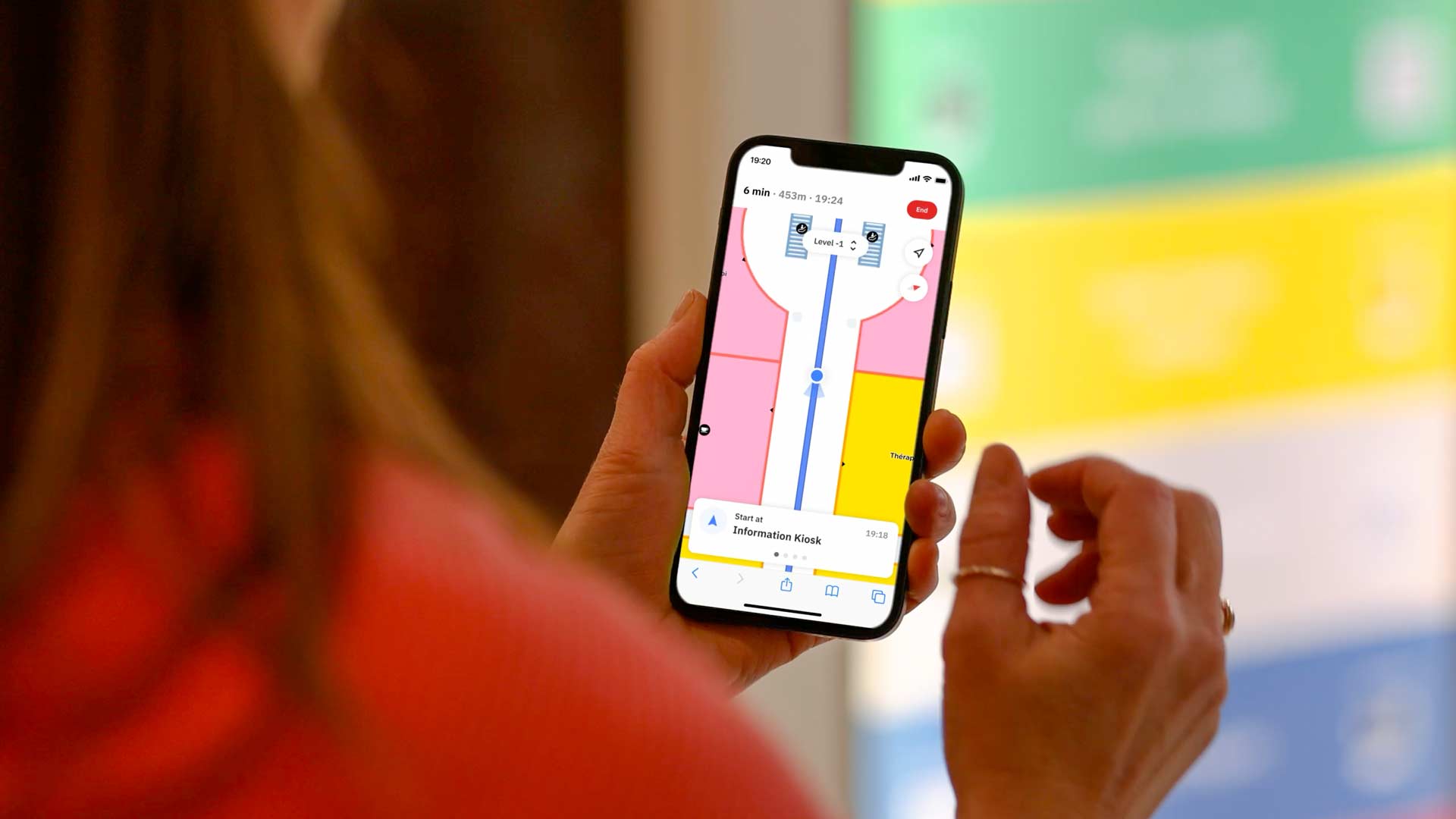 A girl navigation with a phone at a shopping centre for Living Map